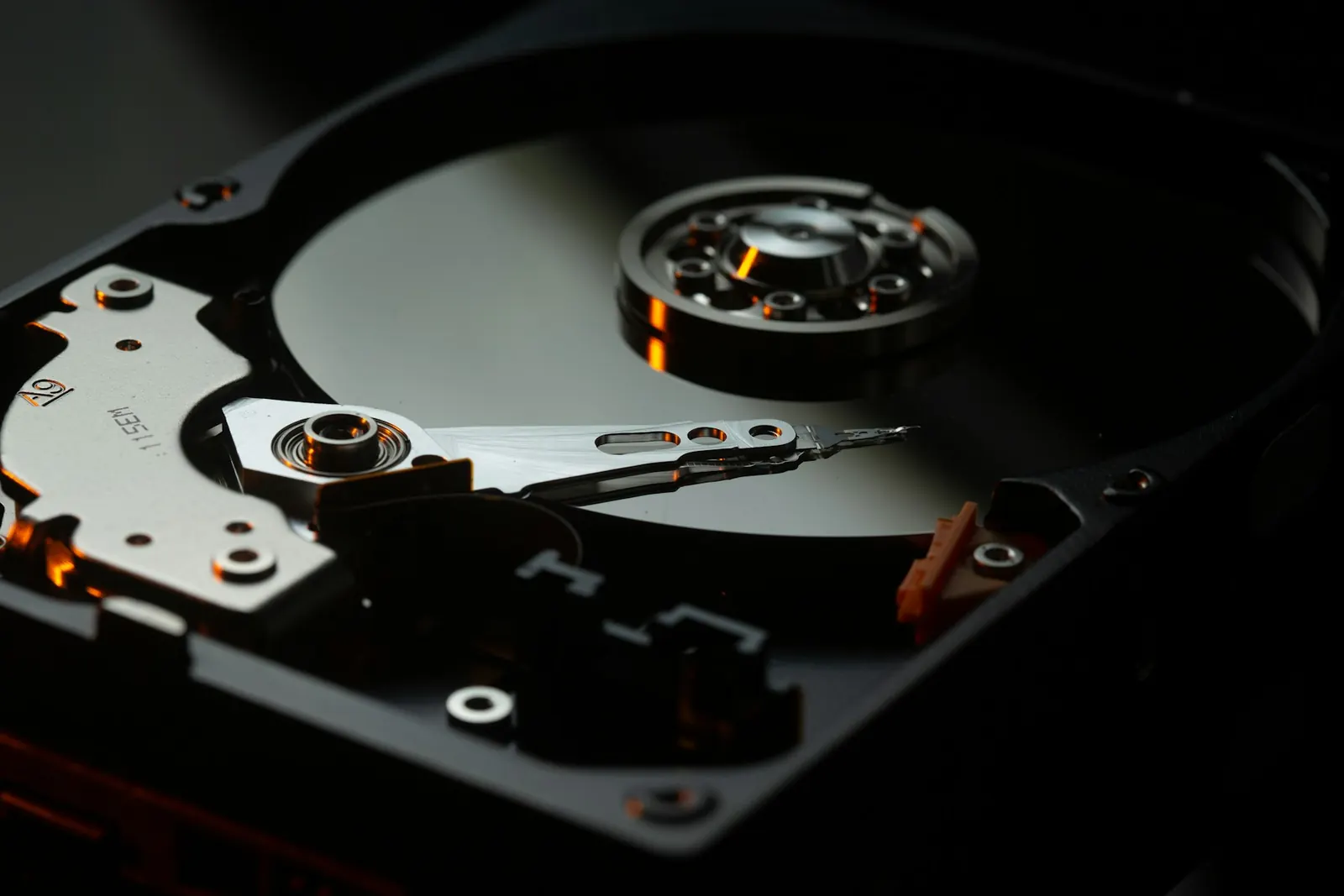 Close view of a hard disk platter and read arm