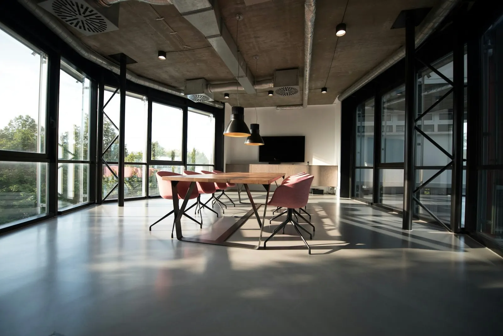 Open office interior with glass walls and rows of desks