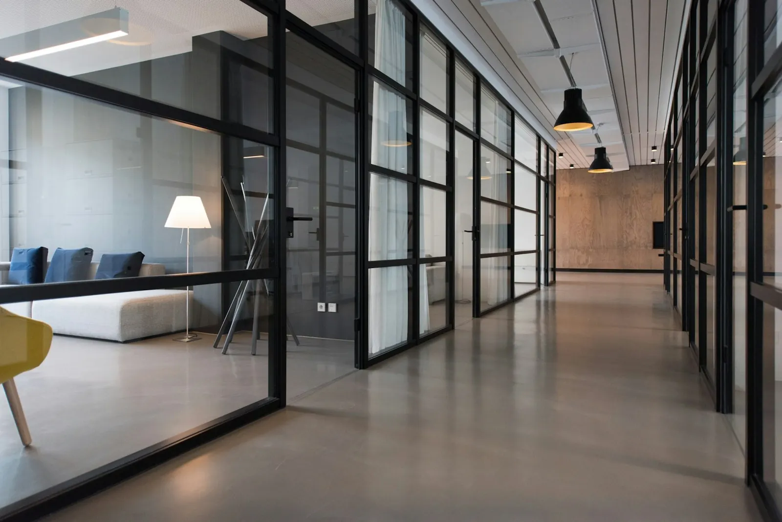Modern office corridor with glass-walled rooms