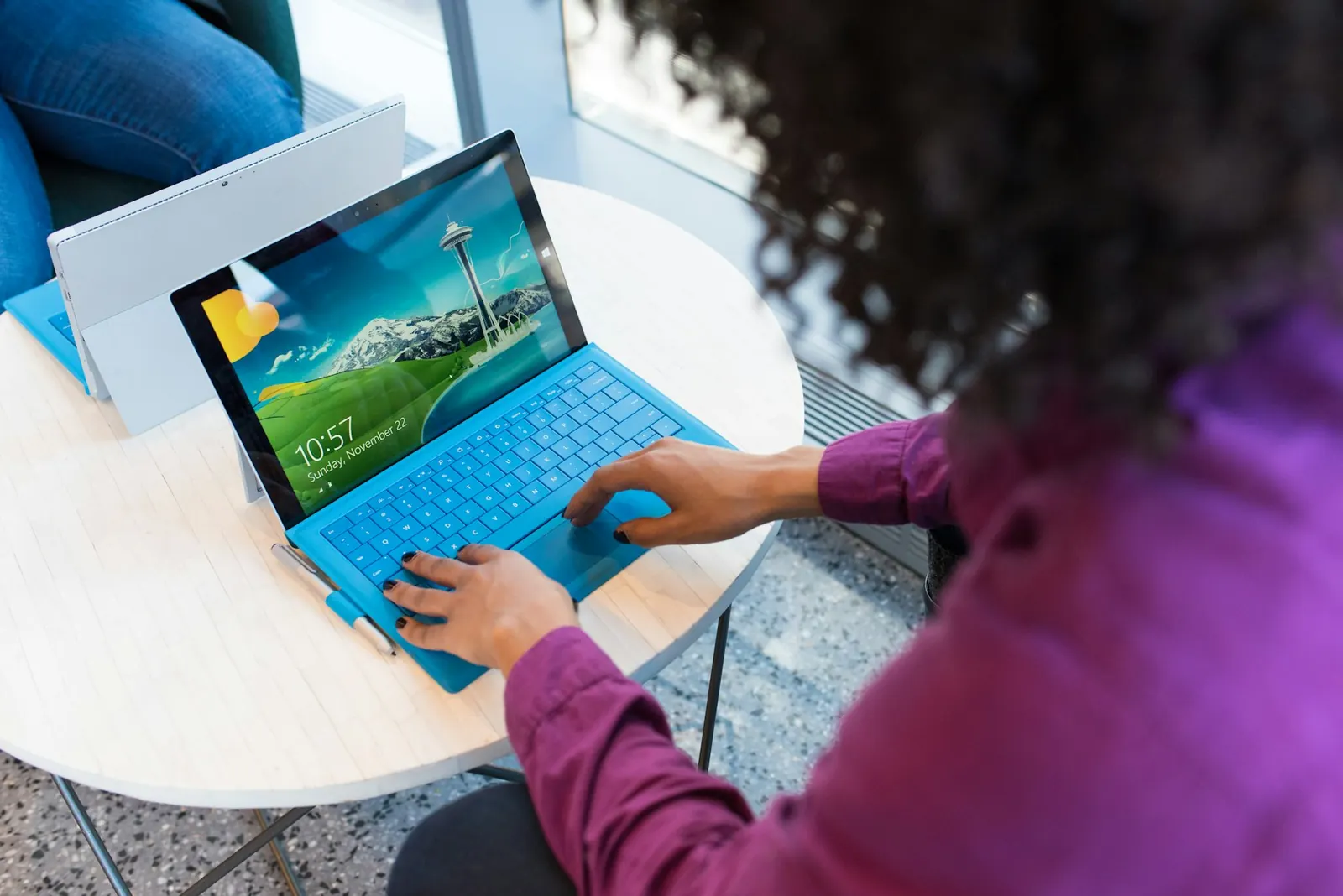 Person using a laptop, photographed over the shoulder