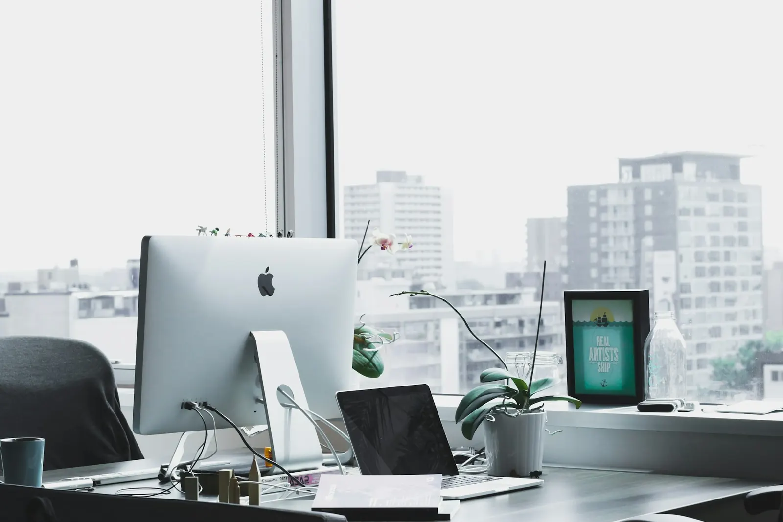 Desk with a monitor facing a large window